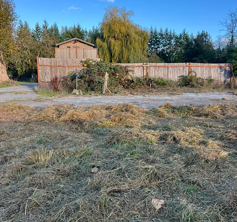 Looking east: 
The parking space is just in front of the fence. Wintertime.
