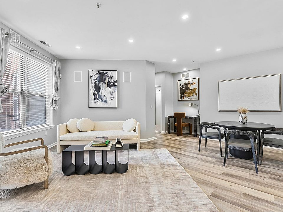 Step into luxury with this chic living room featuring modern art and exquisite furnishings.