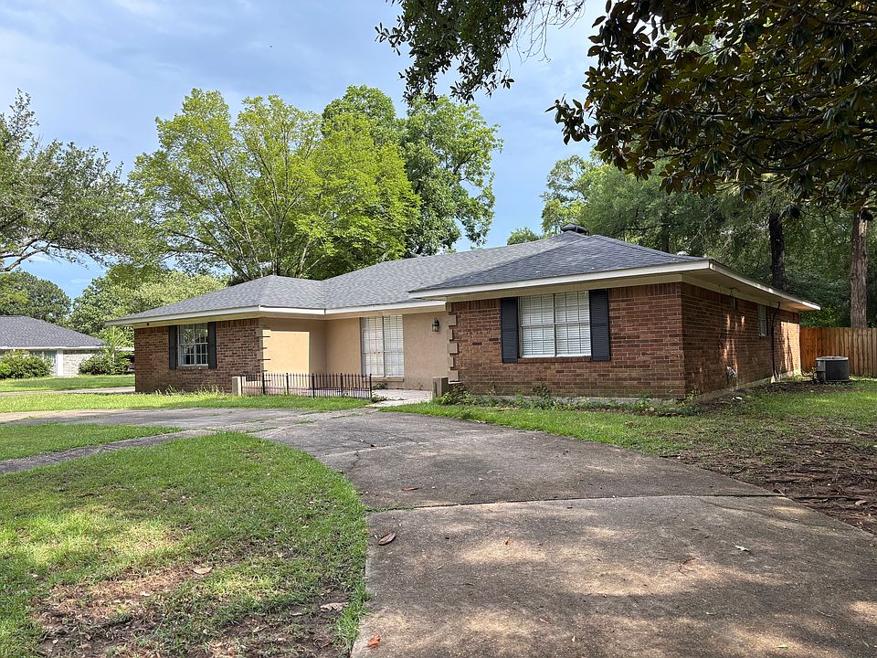 Front of house with circle drive, corner lot