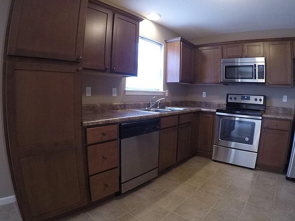 the custom cherry cabinets include a large pantry for plenty