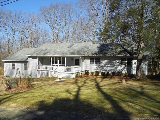 Front of house with covered...