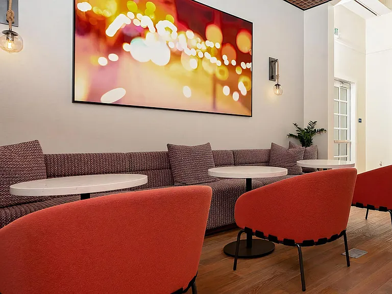 Community Lounge with Plush Chairs and Wall-Mounted Art