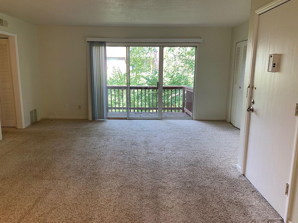 Spacious living space with walk-out to deck & newer carpet.