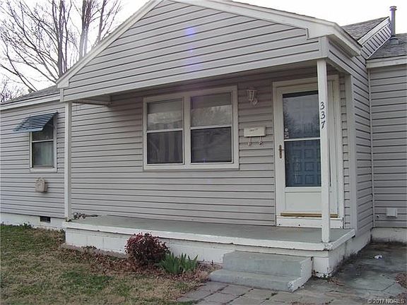 Covered front porch on cute vinyl sided home.