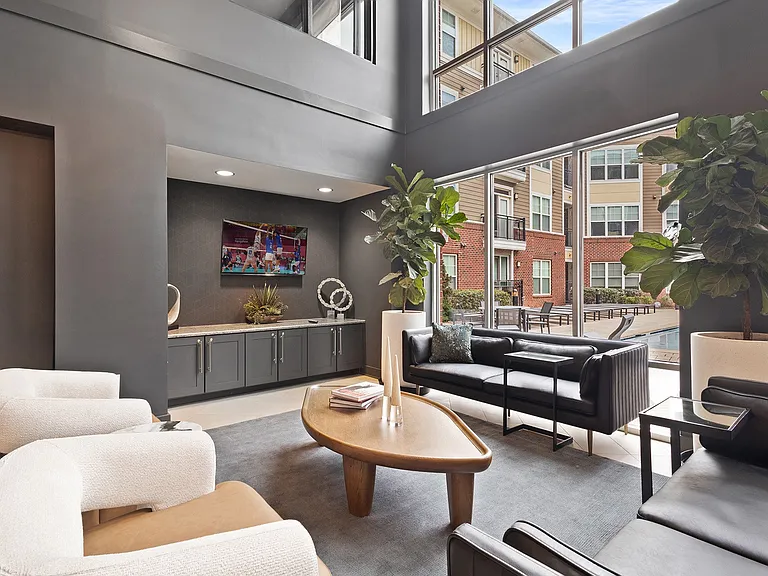 Open, light-filled lounge with comfortable seating and pool views