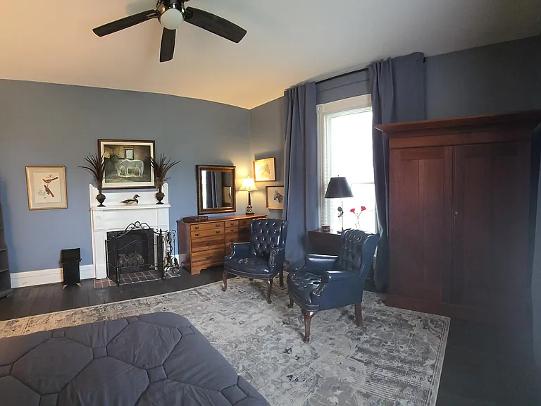 Panoramic view from front corner of bedroom - mirror/dresser; book shelves. Room can convert to office, game room or exercise room (bed flips up to store); table opens up and other furniture can be added per tenant's preference.
