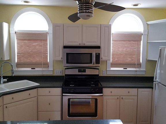 Recessed lighting and Anderson arched double-pane windows