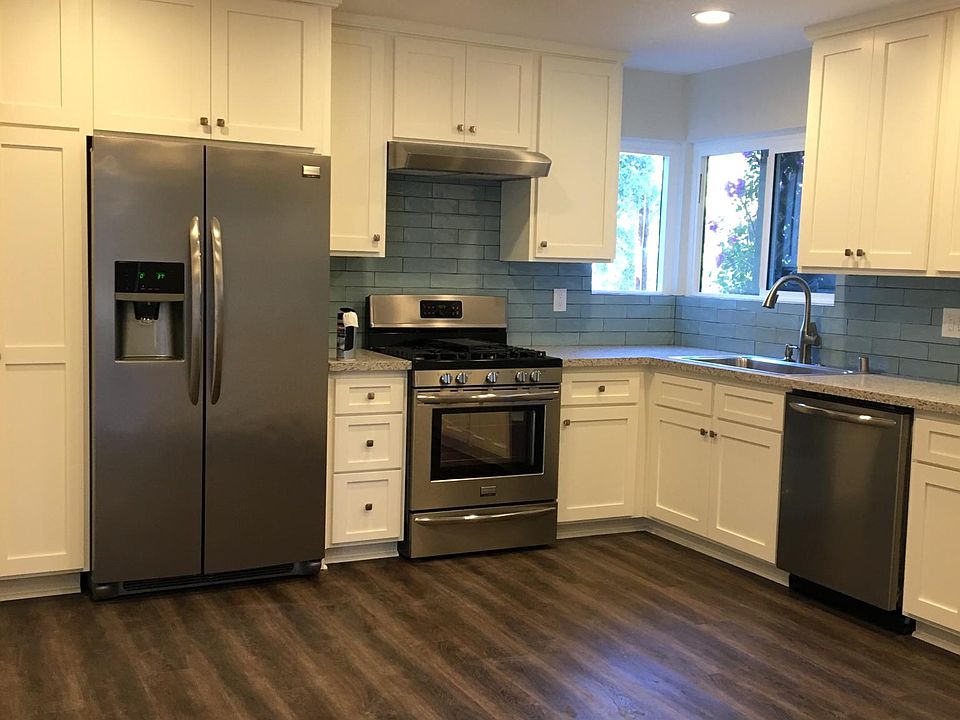 The kitchen features stainless steel appliances, shaker cabinets and handmade tile backsplash. The unit has luxury vinyl plank flooring throughout the living areas.