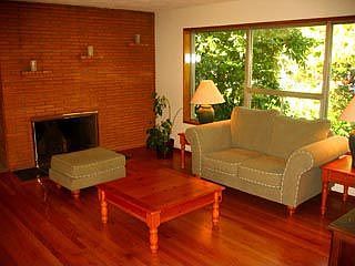 The living room overlooks the back yard with its mature landscaping.