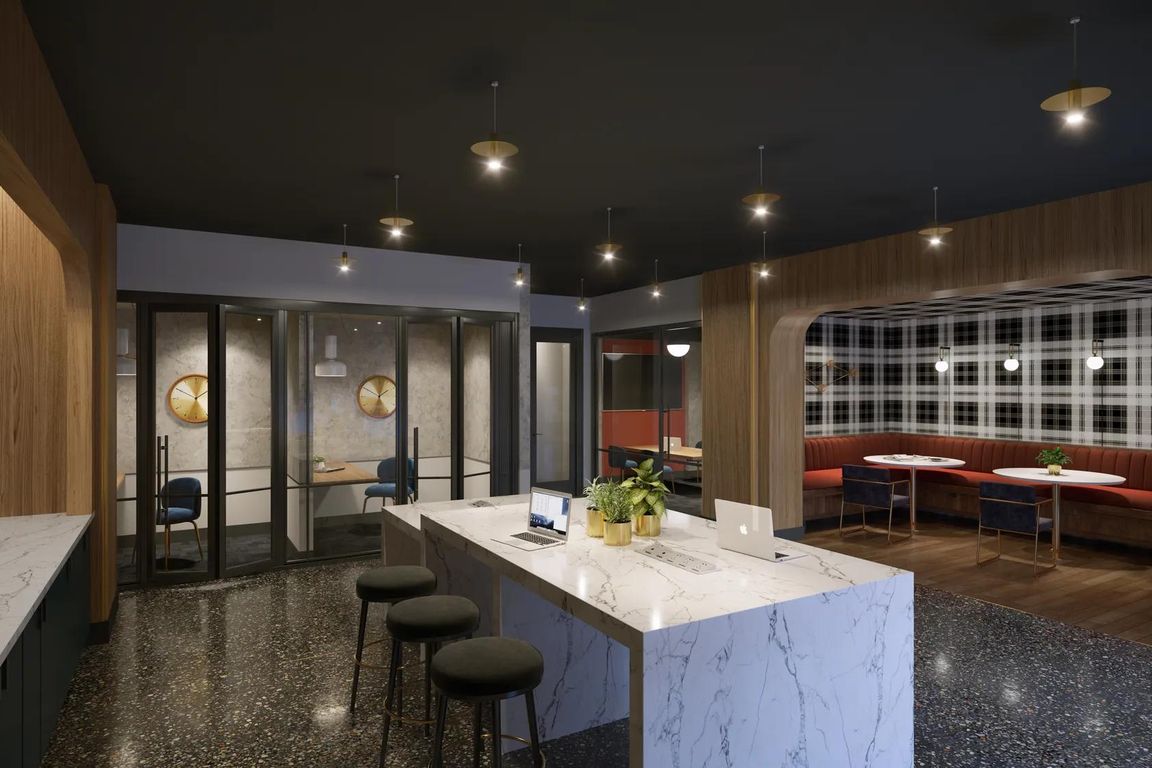 Coworking space with private workstations, comfortable seating areas, and complimentary high-speed Wi-Fi.