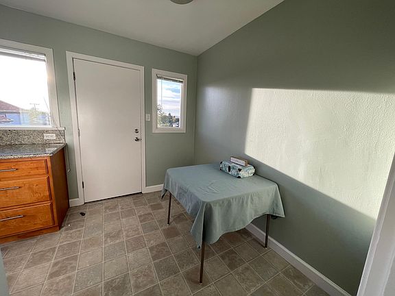 The kitchen table is a welcome place to sit down for a home-cooked meal. The door leads to the private porch to enjoy the view with your favorite beverage. Again, makes this unit more like a house than an apartment.