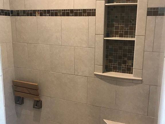 Tiled master bath with bench