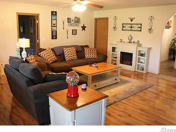 Large open great room with lovely laminate flooring.  Door to den office to the left.