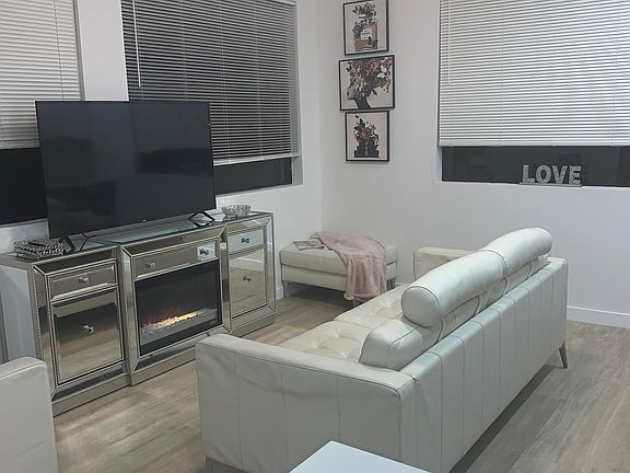 Beautifully Furnished Living Space Smart TV Gorgeous Fireplace Console Large Custom Windows with