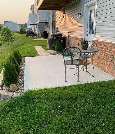 Patio with extra green space and beautiful landscaping