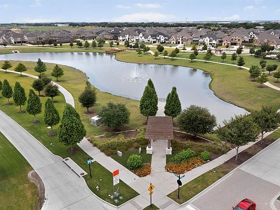 Aerial perspective of suburban area featuring a large body of water