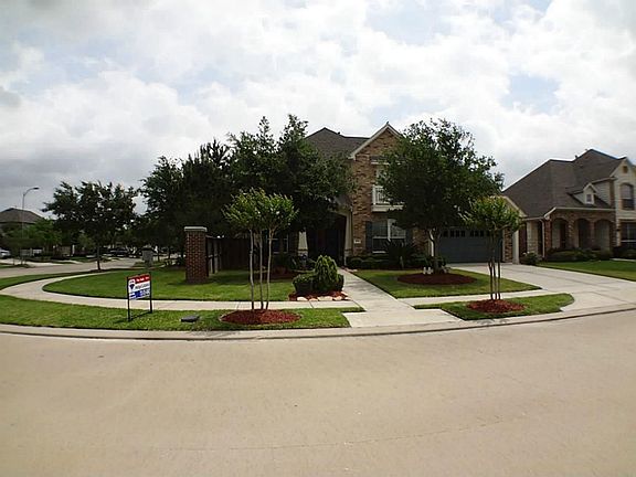 Another view of the home located on a corner lot across from green area and playground