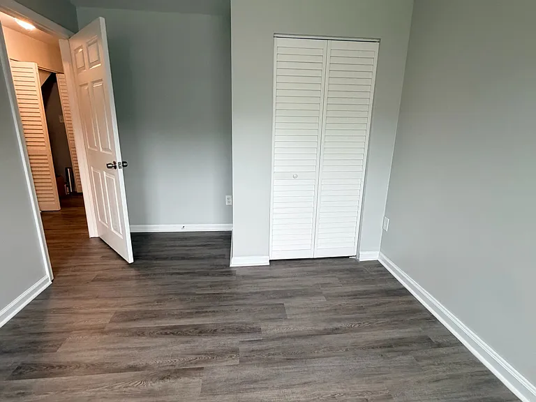 Spacious bedroom featuring a closet and bright windows that provide plenty of natural light.