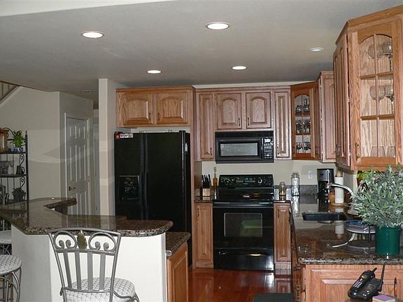 View of kitchen showing cabines and granite counters.
