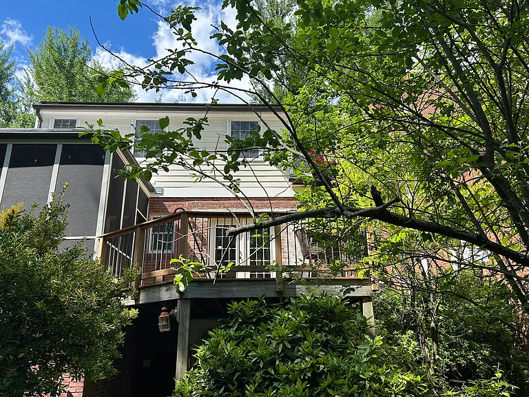 Back view of house showing outside screened in porch and large deck
