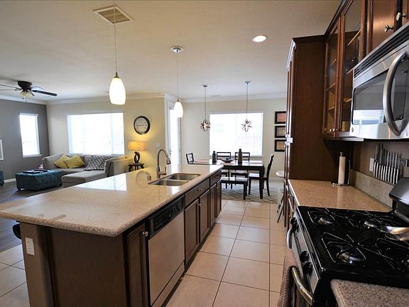 Staged kitchen, dining area, and living room (furnishings not included)
