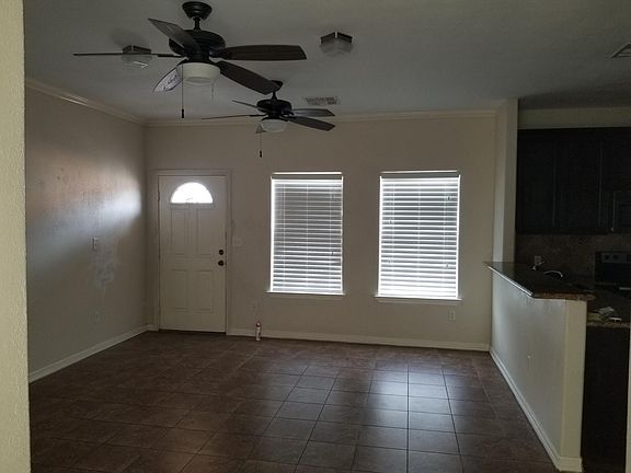 large den with ceiling fans