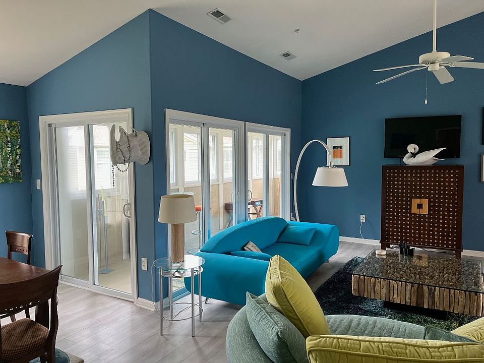 Living room with TV and entertaining area with large central area and lots of comfy, modern seating!