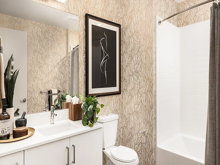 Elegant bathroom with chic leaf-patterned wallpaper, modern white vanity, and stylish framed artwork.
