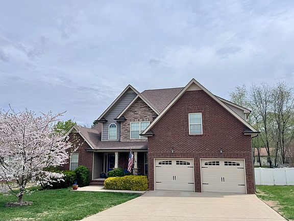 Beautiful curb appeal with brick front, patio, and well-maintained lawn
