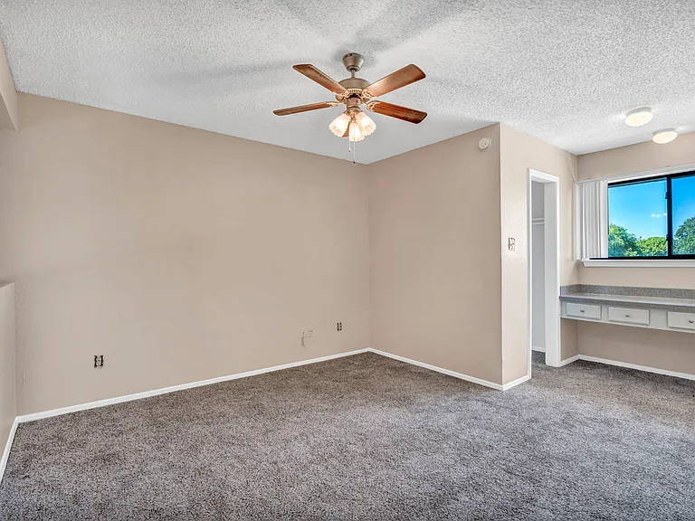 Open-concept floor plan with neutral paint and large windows creating a bright, airy feel.