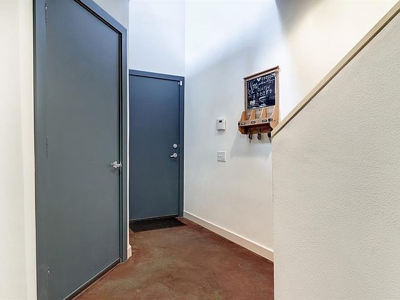 Stained concrete floors on the first floor. Greeted with high ceilings!