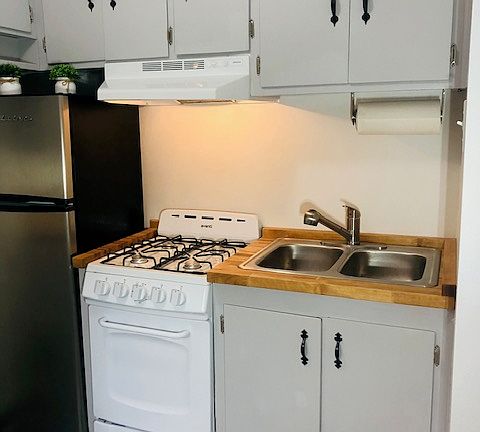 Brand new stove, stainless steel sink, fixture, and countertop.