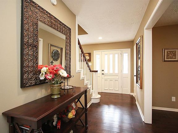Large entryway with formal living area off to the right. Notice th opening has wooden casing. Details like these are not found in newer homes. This space could easily be an office with the addition of French doors. Formal dining area is around the st