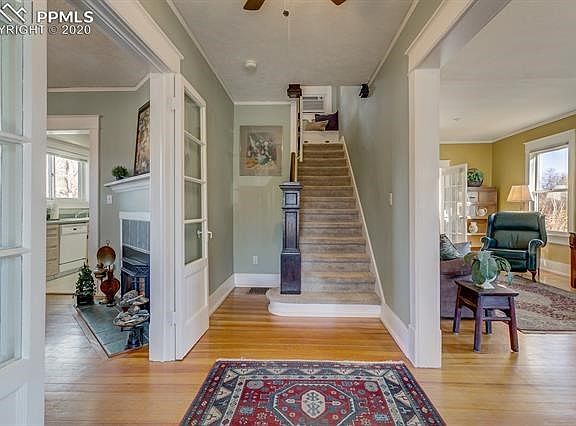The entryway is bright and sunny with welcoming wood floors.