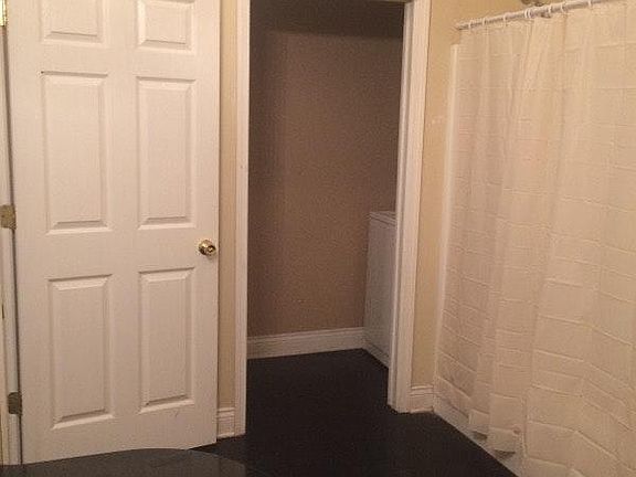 washer and dryer located in room off of huge bathroom