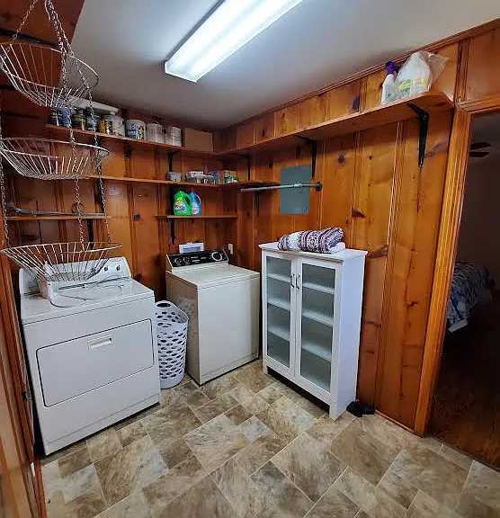 Laundry room located between the kitchen and the master bedroom accessed by pocket doors
