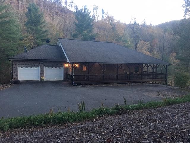 Duplex is nestled in the South Mountains alongside the Henry River, and backs up to 20,949 acres of South Mountains State Park land. It shares the backyard space with private patio for the bottom unit and private wraparound porch, sunroom, and front parki