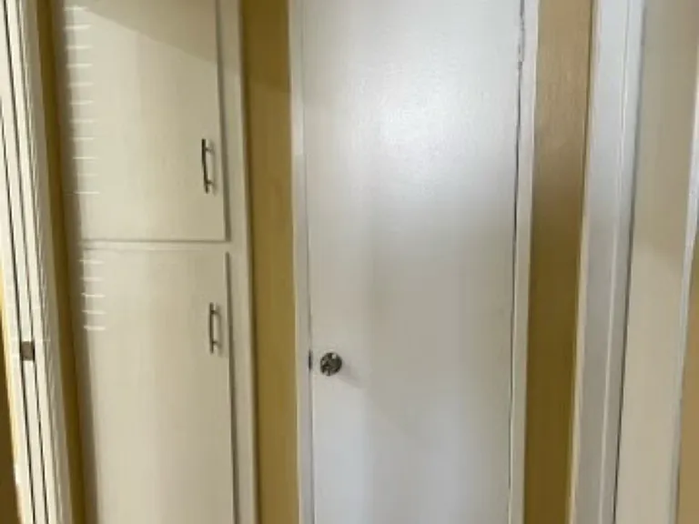 Hallway with linen cabinets