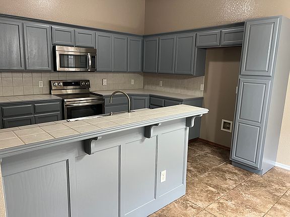 Kitchen with Range, Dishwasher, Microwave, and disposal.