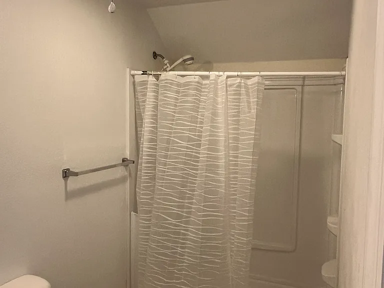 Full sized bathroom has a walk-in shower