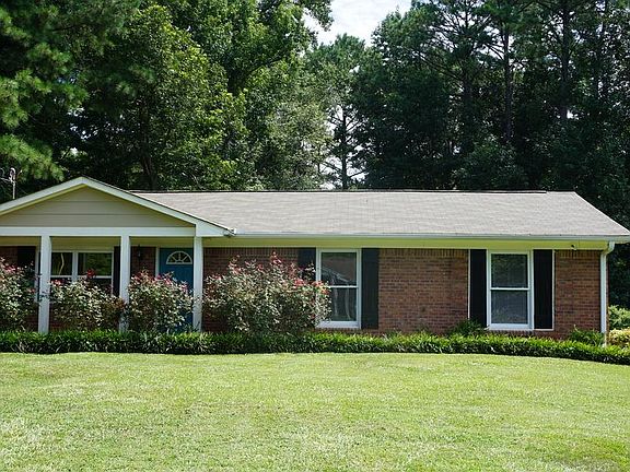 Sunshine and roses accent the house and lawn.