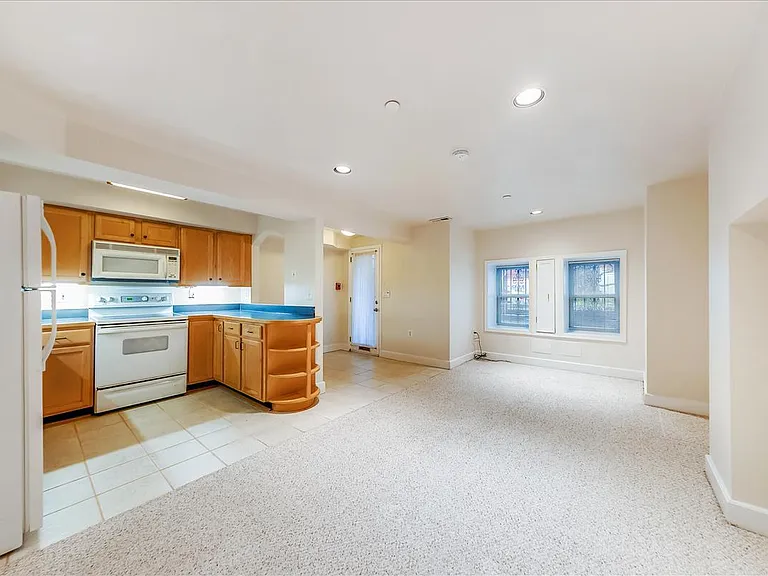 Open kitchen off the foyer and open living area.