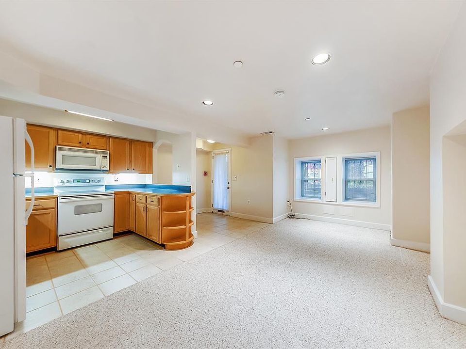 Open kitchen off the foyer and open living area.
