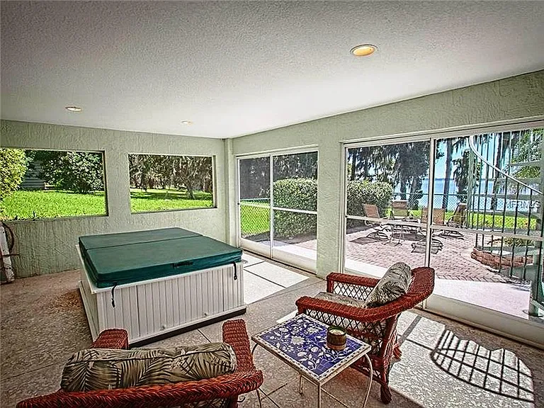 The Pool deck also has a screened in patio with a Hot Tub and spiral staircase up to the main screened porch. All decks, patios and screened in porches look out on the lake with spectacular views.