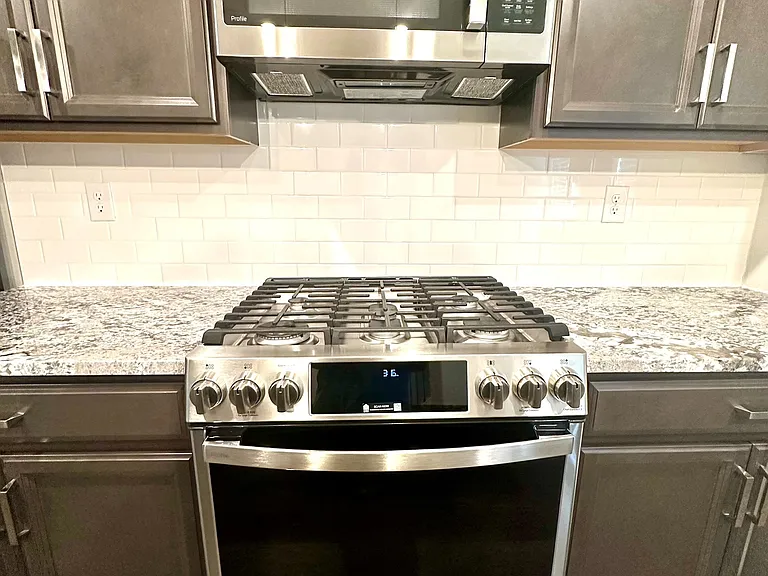 Energy efficient stainless steel appliances including gas cooktop, microwave and wall oven