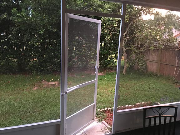 Screened porch with fenced in backyard