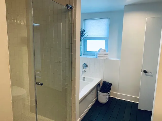 Bathroom that connects to master bedroom and to hallway; large soaking tub and separate shower; window in the bathroom, with privacy.