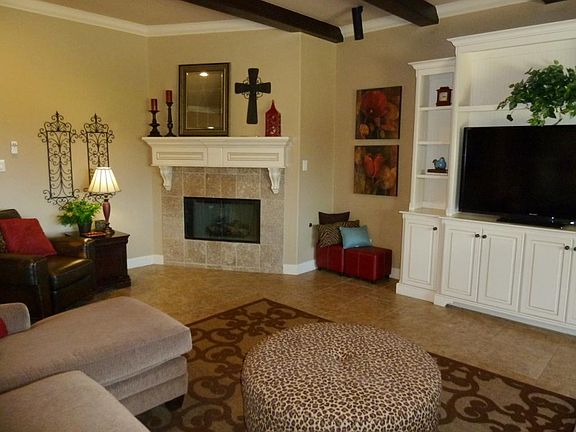 Corner fireplace is a lovely accent in the spacious den.