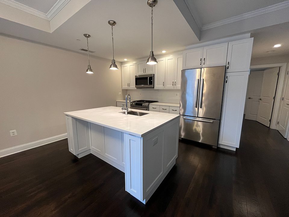Kitchen island, room for 2 chairs. Washer/dryer combo in hallway closet to right (not pictured)