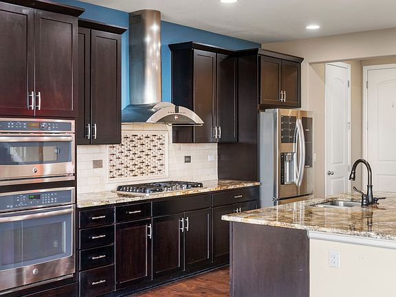 Gourmet kitchen with vented hood, dual oven and the top one is also a microwave